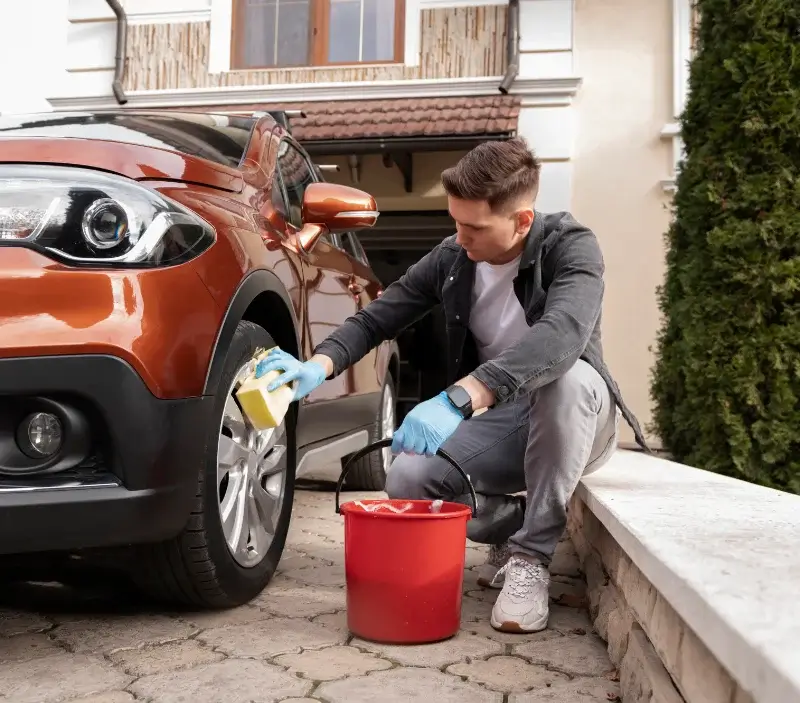 Lavage auto à domicile Les Mesnuls : professionnel intervenant sur un véhicule